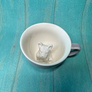 creature cups dog inside mug